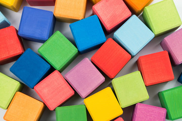 Fototapeta na wymiar Flat lay of colorful wooden cubes as background. Top view.