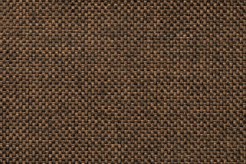 Dark brown background of dense woven bagging fabric, closeup. Structure of the textile macro.