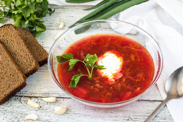 Vegetables and meat in red beetroot soup or borsch with sour cream