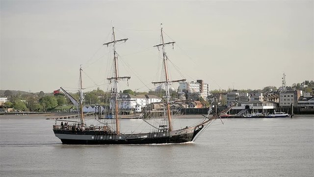 Traditional old sailing ship sailing past Gravesend on the River Thames; slow motion
