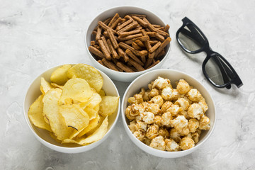 glasses, snacks, beer for whatchig film on stone background