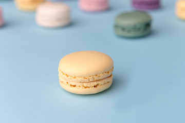 Sweet colorful macaroons on blue table background