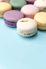 Sweet colorful macaroons on blue table background.