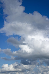 Blue sky with flying clouds over horizon, heaven.