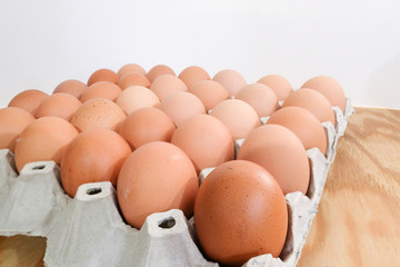 A pack of eggs on wooden background.