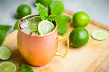 Cold Moscow Mule cocktail in copper mug on the rustic background. Shallow depth of field.