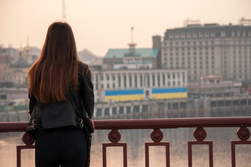 Silhouette of Little girl and mother are fishing at the Bottom view of Bridge. Sunset at Akashi Kaikyo Bridge, suspension bridge, spanning the Seto Inland Sea from Awaji Island to Kobe, Japan