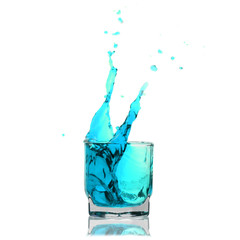 light-blue cocktail splashing on a glass on white background