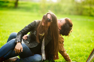 Two pretty young women cheerfully spend time in the spring park.