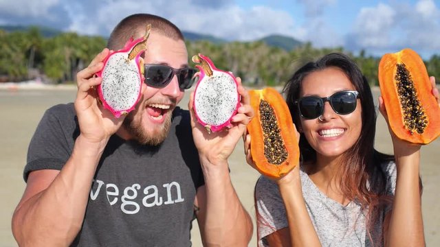 Happy Multiracial Couple Having Fun With Fruits on Beach. Healthy Lifestyle Concept. Slow Motion. HD, 1920x1080. 