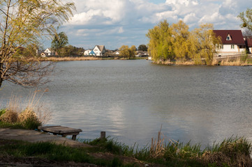 Fototapeta premium The structure of the small river rural landscape. cloudy skies. inwardness