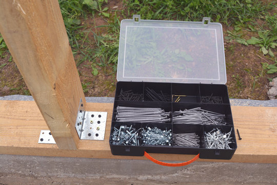 Plastic box with nails and scerws on foundation