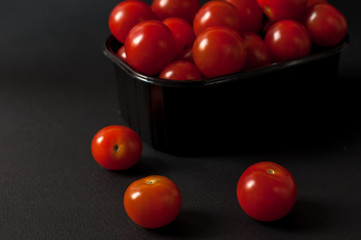 Tomatoes on black background.