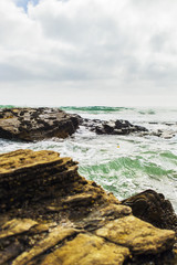 Rocks on beach shoreline.
