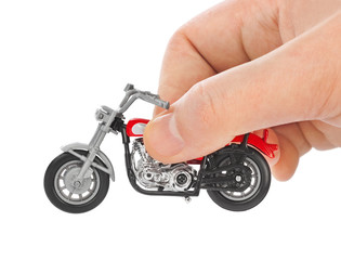 Naklejka premium Hand with toy motorbike