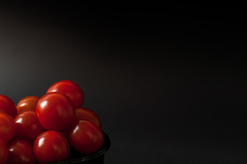 Tomatoes on black background.