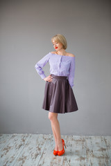 beautiful young woman in leather skirt and purple blouse