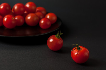 Tomatoes on black background.