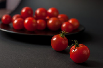 Tomatoes on black background.