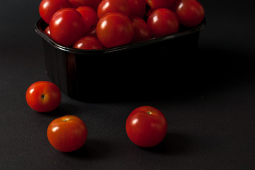 Tomatoes on black background.