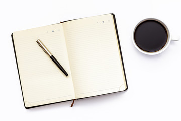 Black open diary, pen and Cup of black coffee on a white background. Minimal business concept for the workplace in the office.