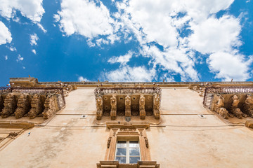 Beautiful baroque balconies of Palazzo Nicolaci Villadorata, Noto, Sicily, Italy.