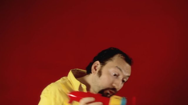 A grownup man starting the engine of a toy plane and flying away with it. Funny scene.
