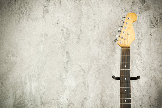 Close Up Detail Of An Electric Lead Guitar with old brick wall background.Music background concept with free space for text.