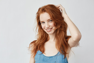 Emotive sincere happy girl with red hair smiling.