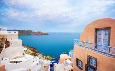 Oia town on Santorini island, Greece. Traditional and famous houses and churches with blue domes over the Caldera, Aegean sea