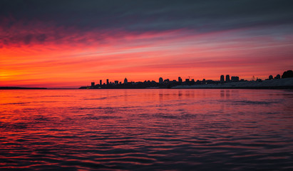 Magnificent pink sunset over the urban landscape and the river beautiful background