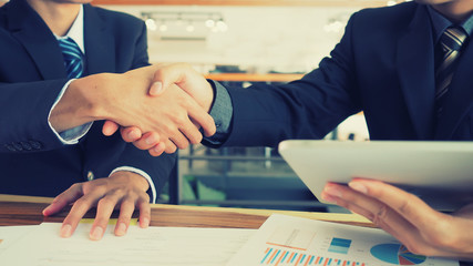 Businessmen handshake, business partnership concept, vintage color tone