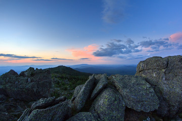 Sunset over the mountainous terrain. The nature of the Southern Urals. Sunset sky over the forest and the mountains.