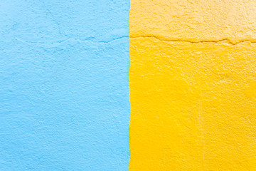 Stucco blue and yellow wall texture background.
