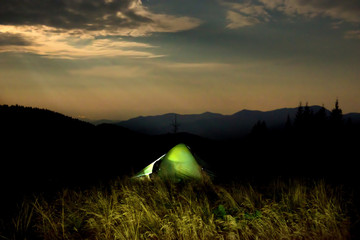 Illuminated green camping tent
