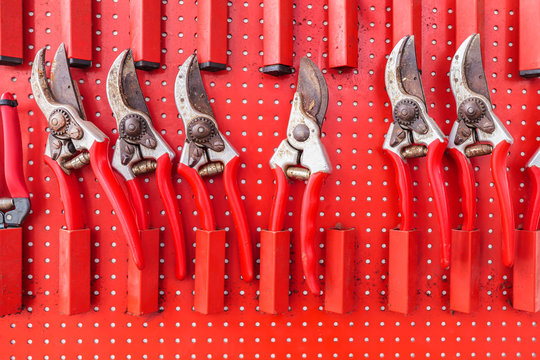 Row of red used garden shears