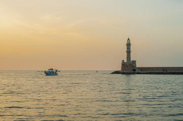 Greece, Crete, sunset in Chania (Xania) evening light to city. Boat sun and light house view