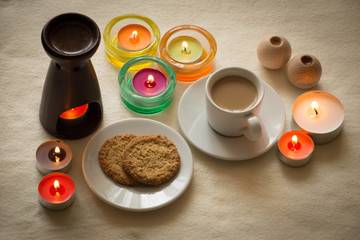 Obraz na płótnie Canvas Homemade cup of coffee and cookies surrounded by candles, hygge time 