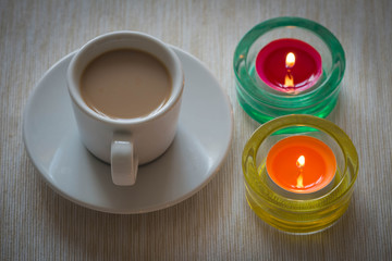 Homemade cup of coffee surrounded by candles / hygge time