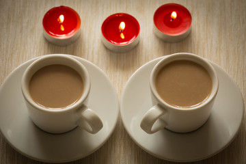 Homemade cup of coffee surrounded by candles / hygge time