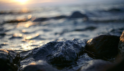 Patches of light from the sunset sun on waves