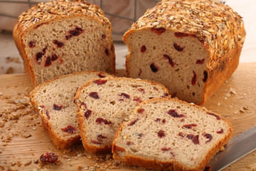Whole grain bread with cranberry on a wooden board