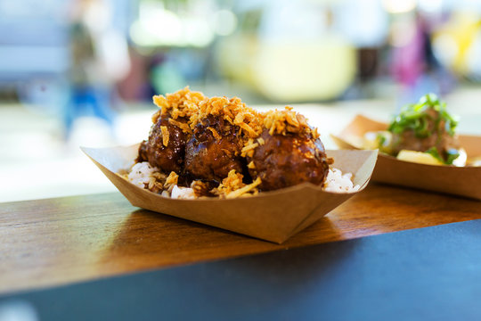 Meatballs With Rice And Crispy Onion In A Food Truck.