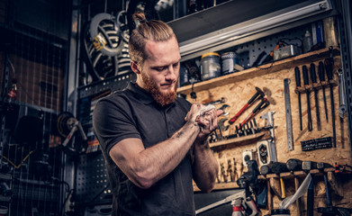 Mechanic cleans his arms after bike service manual.