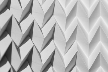 Closeup abstract white folded origami geometrical jigsaw paper pattern background - obrazy, fototapety, plakaty