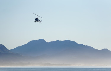 Fototapeta na wymiar Helicopter and mountains