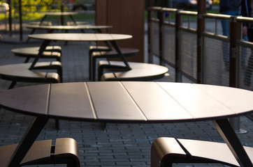 Empty tables of a street cafe at sunset on a summer evening