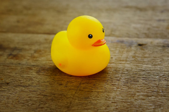 yellow duck toys over wooden table background