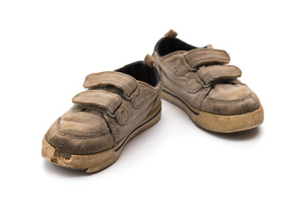 pair of old grey shoes on a white background