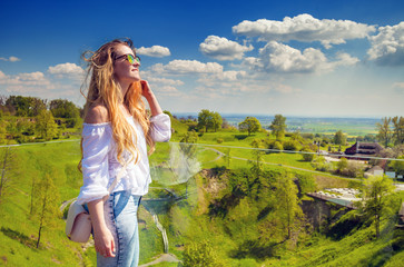 Girl on background of green meadow and hills